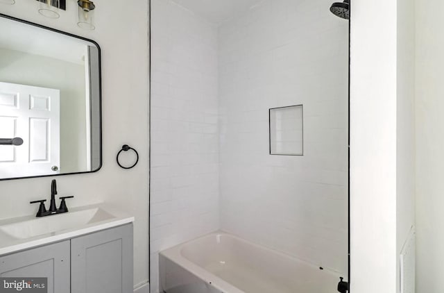 bathroom featuring washtub / shower combination and vanity