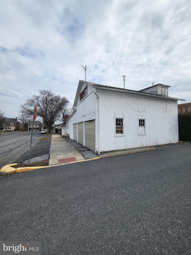 view of home's exterior featuring a detached garage