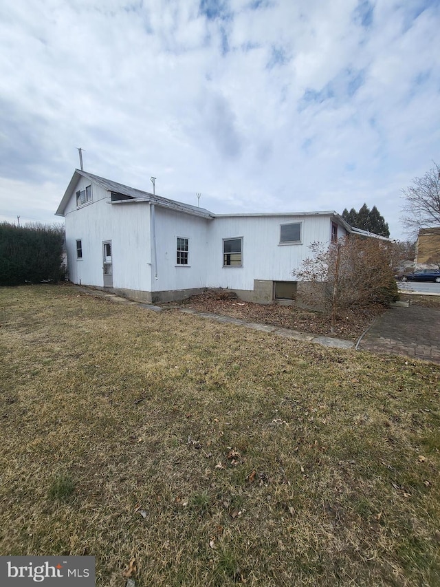 view of property exterior with a yard