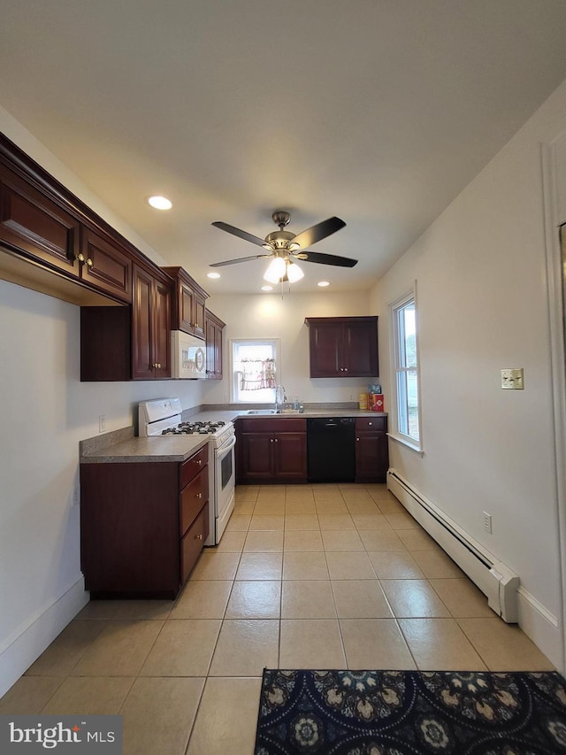 kitchen with white appliances, light tile patterned flooring, a baseboard radiator, and a wealth of natural light