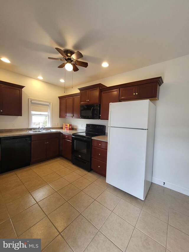 kitchen with light tile patterned floors, light countertops, black appliances, a sink, and recessed lighting