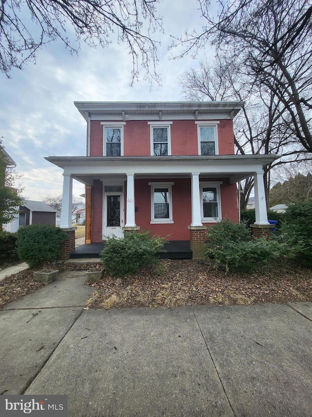 view of front facade featuring a porch and brick siding