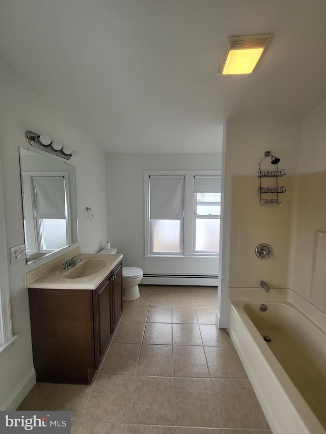 bathroom featuring a tub to relax in, toilet, a baseboard heating unit, vanity, and tile patterned flooring