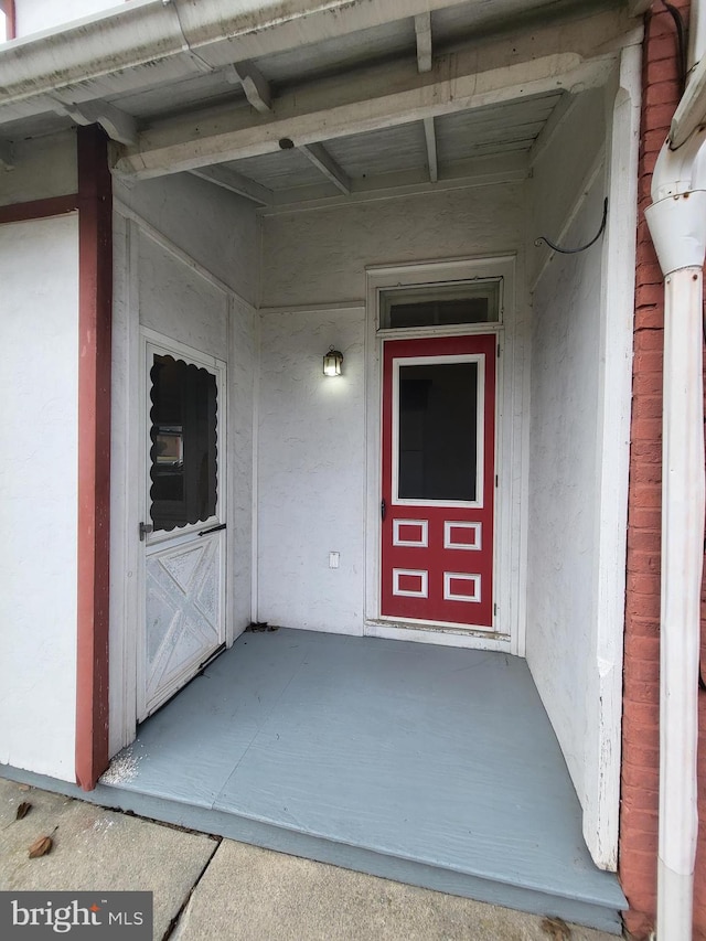 doorway to property with stucco siding