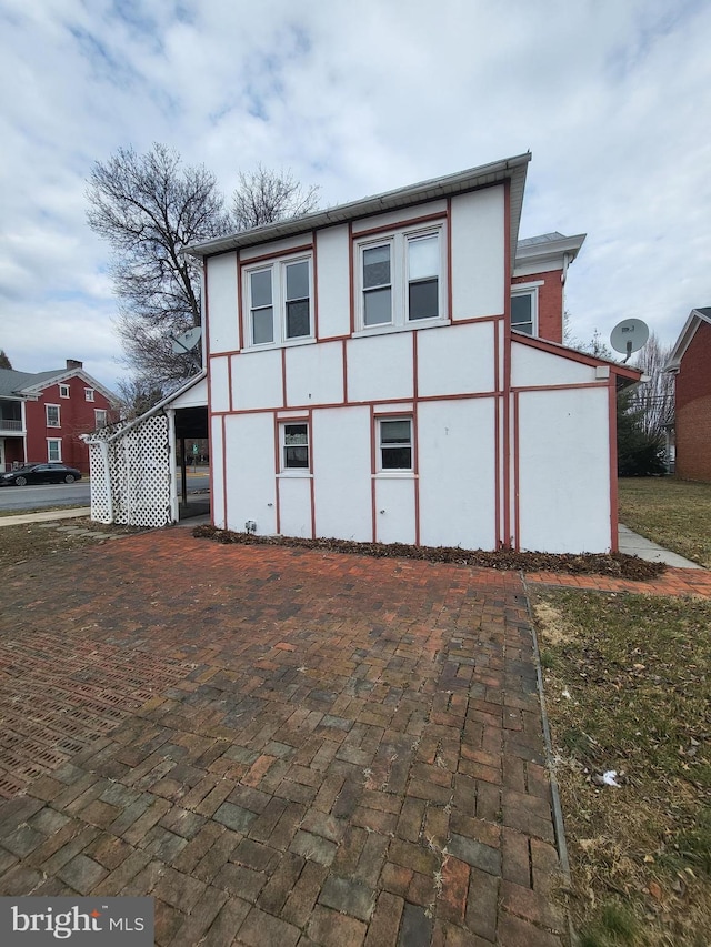 view of side of home with stucco siding