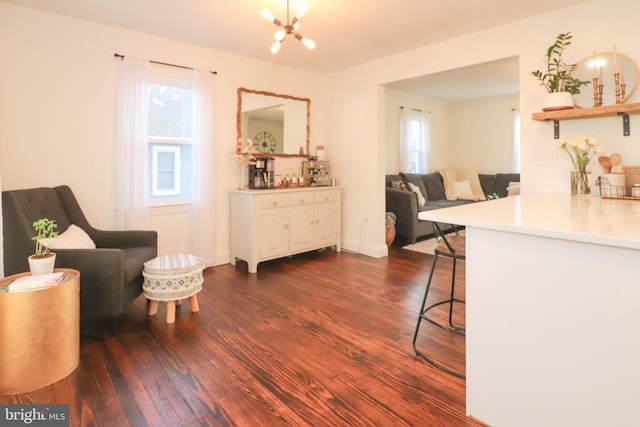 interior space featuring a notable chandelier and dark wood finished floors