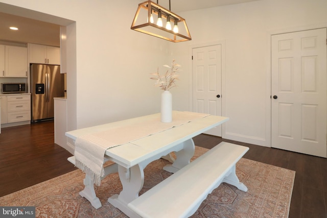 dining room featuring baseboards, dark wood finished floors, and recessed lighting