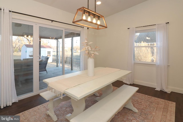 dining space with dark wood finished floors, a wealth of natural light, and baseboards