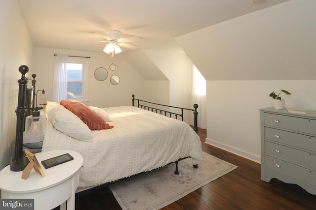 bedroom with lofted ceiling, dark wood-type flooring, a ceiling fan, and baseboards