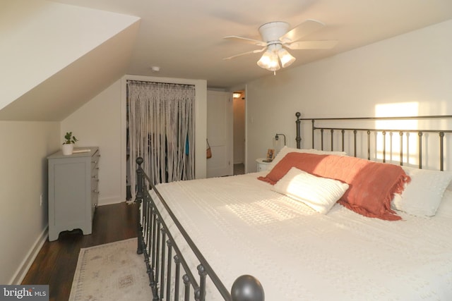 bedroom with lofted ceiling, baseboards, a ceiling fan, and dark wood-type flooring