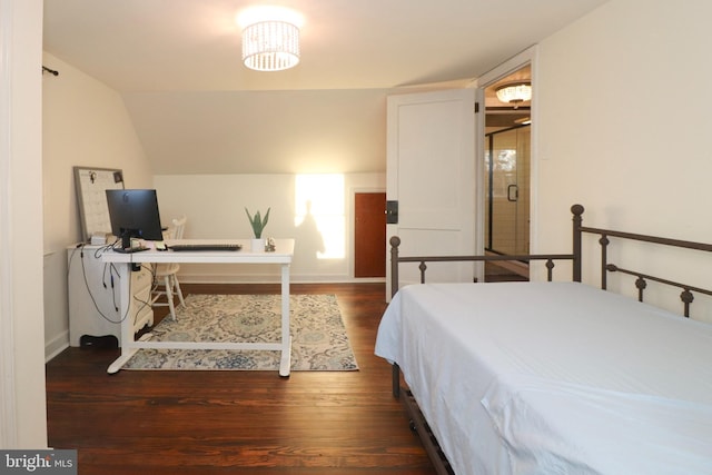 bedroom with vaulted ceiling and dark wood-type flooring