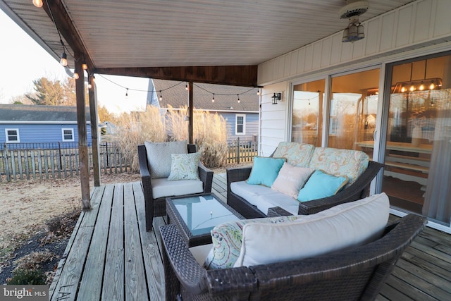 wooden deck featuring fence and an outdoor hangout area