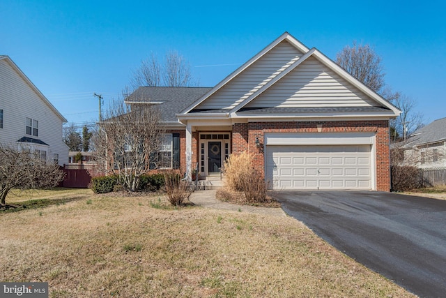 view of front of property featuring brick siding, an attached garage, a front yard, roof with shingles, and driveway