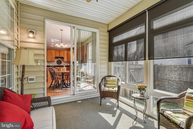 sunroom featuring an inviting chandelier