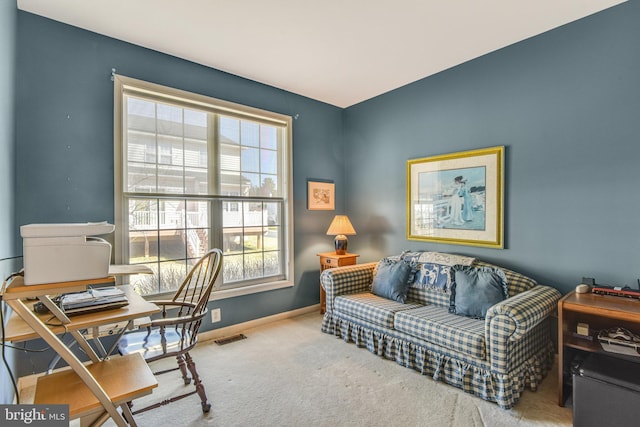 carpeted home office featuring visible vents and baseboards