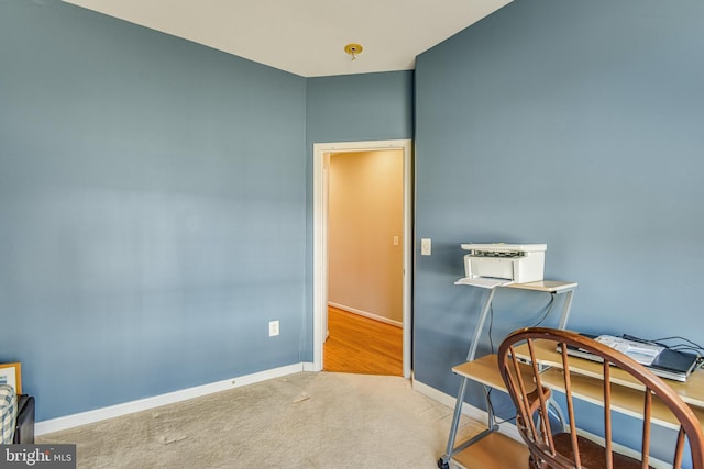 carpeted office featuring baseboards