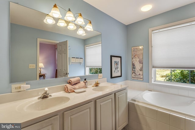 bathroom featuring double vanity, a bath, and a sink