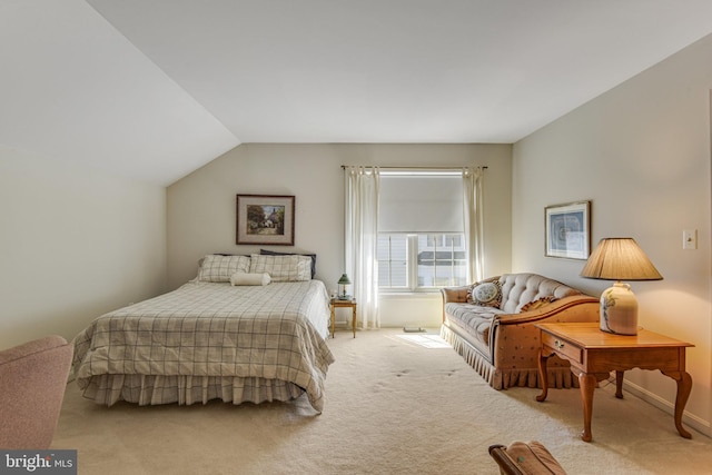 bedroom with baseboards, light carpet, and lofted ceiling