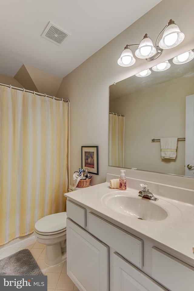 bathroom featuring vanity, visible vents, lofted ceiling, tile patterned flooring, and toilet