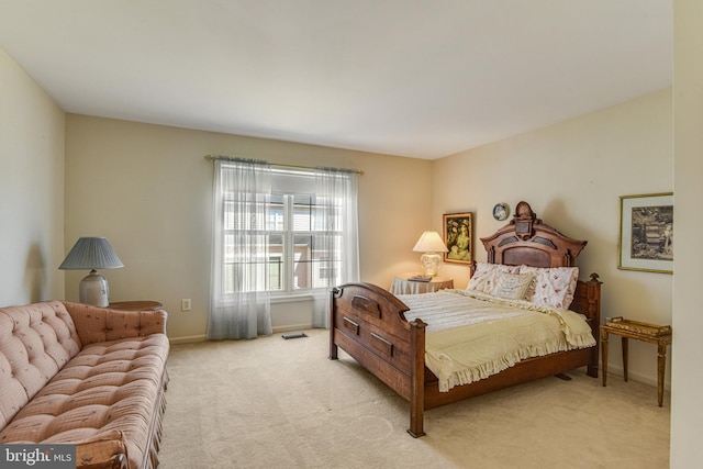 bedroom featuring baseboards and light carpet