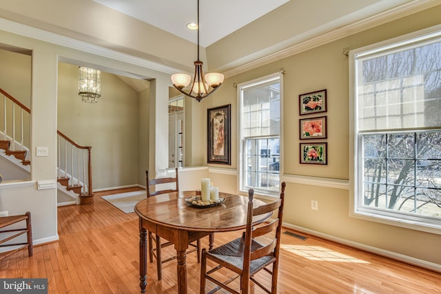 dining space featuring a chandelier, visible vents, stairway, and a wealth of natural light