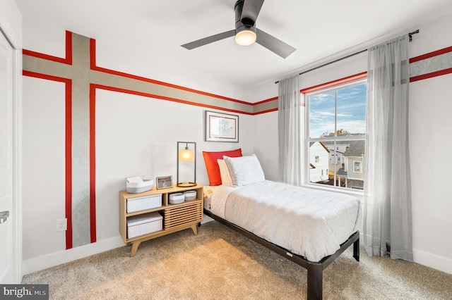 carpeted bedroom featuring a ceiling fan and baseboards