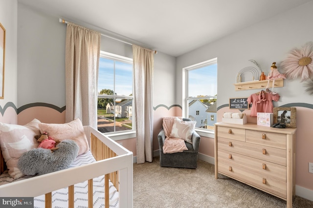 bedroom featuring baseboards, multiple windows, and light colored carpet