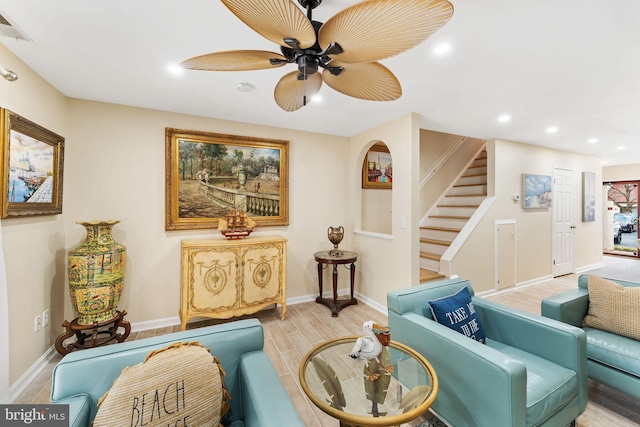 living area featuring visible vents, a ceiling fan, light wood-style flooring, stairway, and recessed lighting