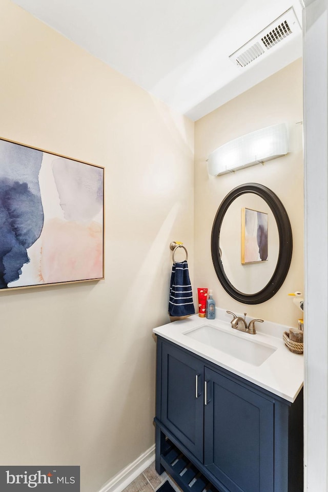 bathroom featuring vanity, visible vents, and baseboards