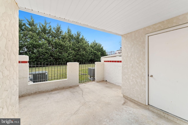 view of patio with central AC and fence