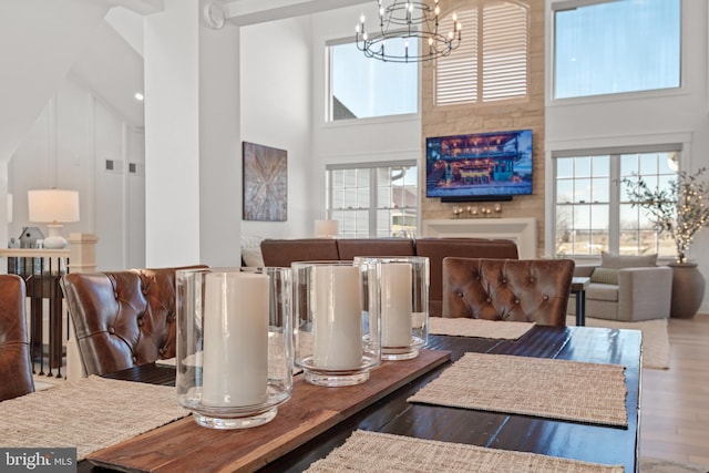 dining space with a chandelier, a high ceiling, and wood finished floors