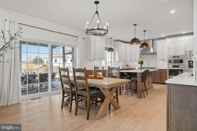 dining room with recessed lighting, visible vents, and light wood-style flooring