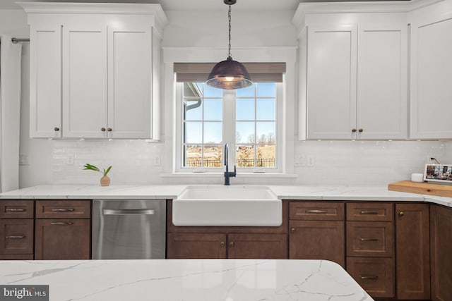 kitchen featuring decorative backsplash, dishwasher, white cabinetry, and a sink