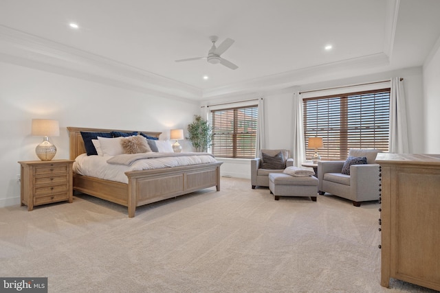 bedroom with crown molding, a raised ceiling, and light carpet