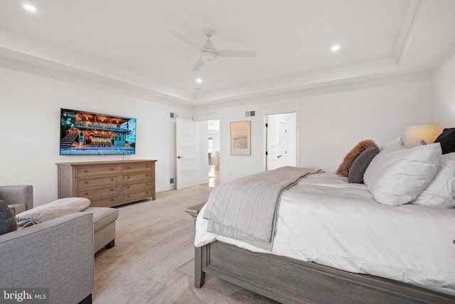 bedroom with ornamental molding, a ceiling fan, a tray ceiling, recessed lighting, and light colored carpet