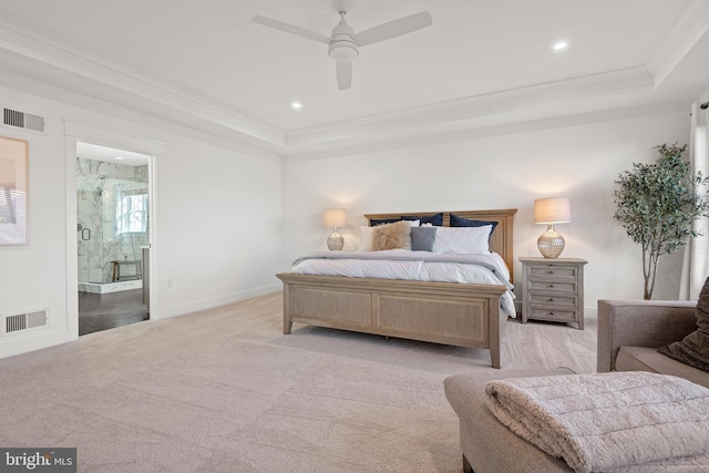 bedroom featuring a raised ceiling, visible vents, and ornamental molding