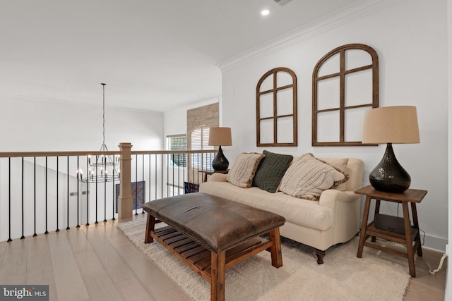 living room featuring baseboards, light wood finished floors, recessed lighting, crown molding, and a notable chandelier