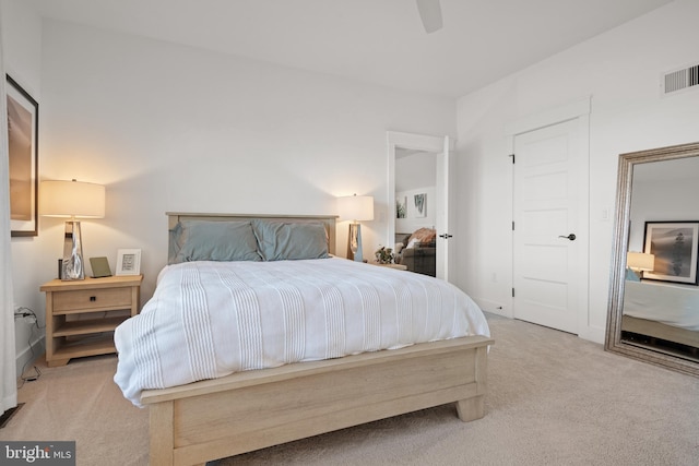 bedroom with carpet flooring, a ceiling fan, and visible vents