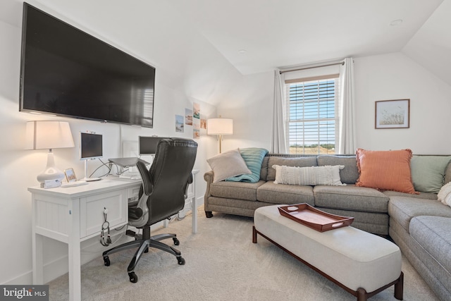 office space featuring lofted ceiling and light colored carpet