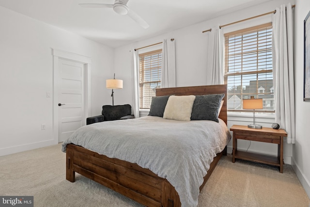 bedroom featuring ceiling fan, baseboards, and carpet floors