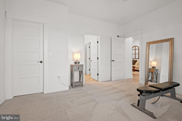 workout room featuring baseboards, carpet floors, and visible vents