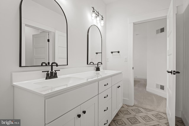 full bathroom with double vanity, visible vents, and a sink