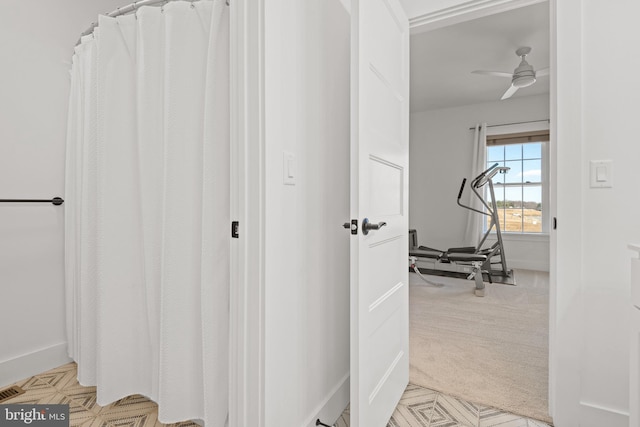 corridor with light colored carpet and baseboards