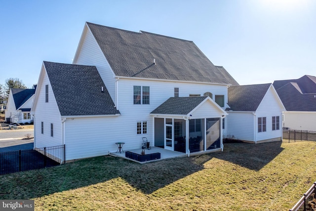 back of house with a yard, fence, a shingled roof, and a sunroom