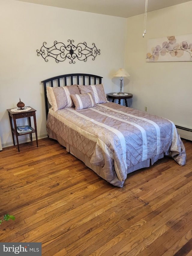 bedroom with hardwood / wood-style flooring