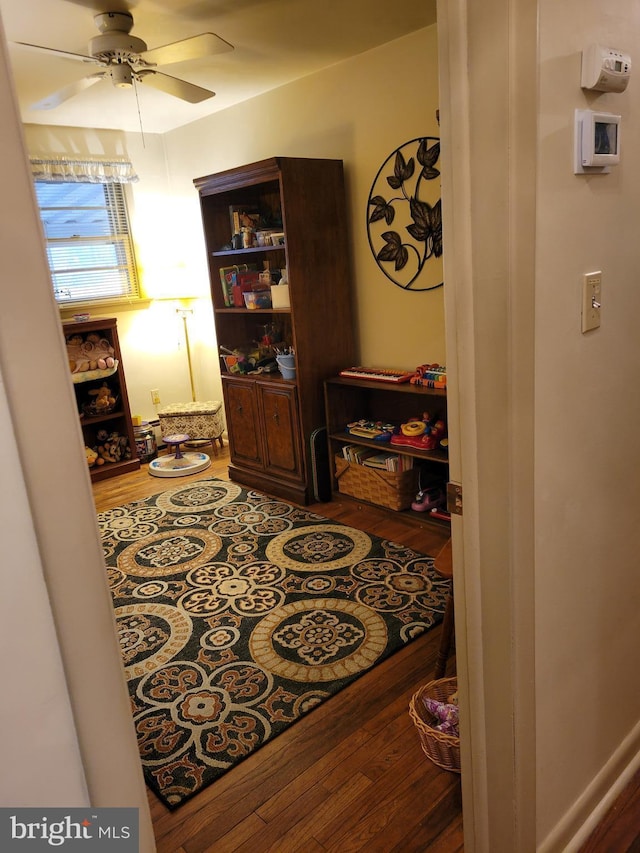 interior space featuring ceiling fan and wood finished floors