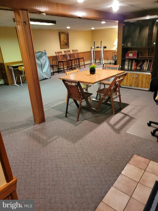 dining room with carpet and wainscoting