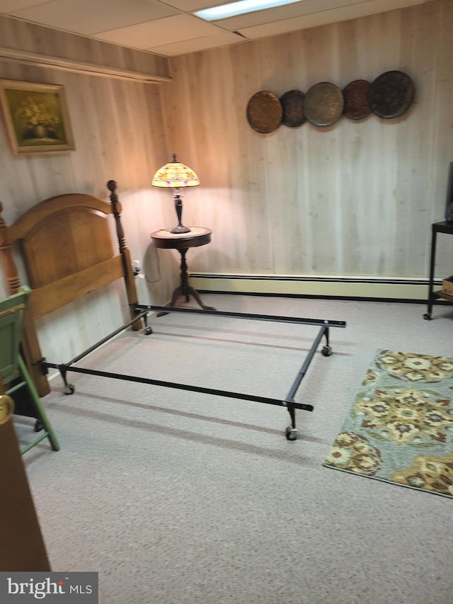 carpeted bedroom featuring wooden walls