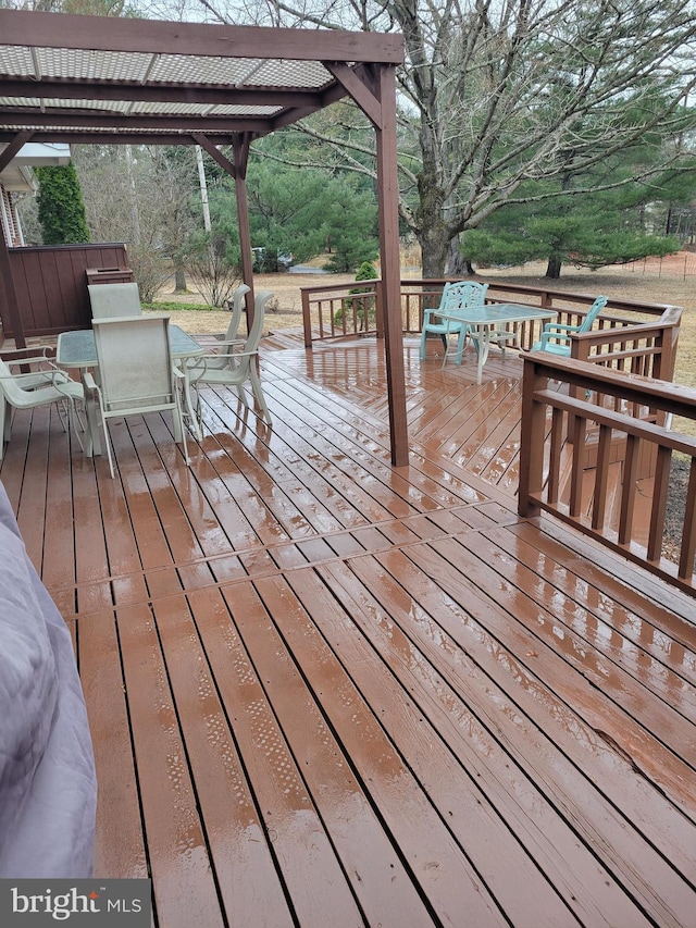 wooden terrace featuring outdoor dining space