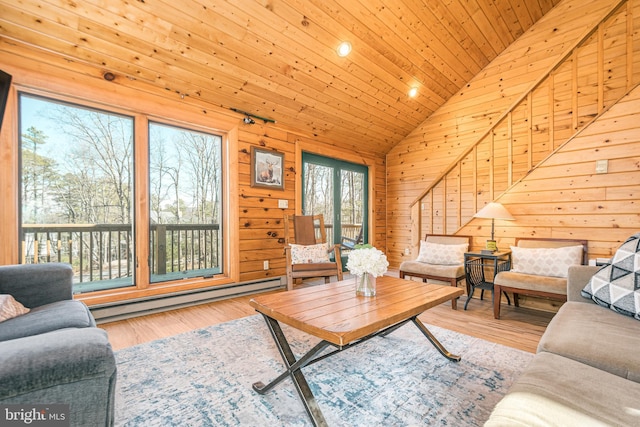 living room with a baseboard heating unit, wood ceiling, wood walls, and wood finished floors